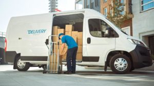 person loading boxes into sprinter van